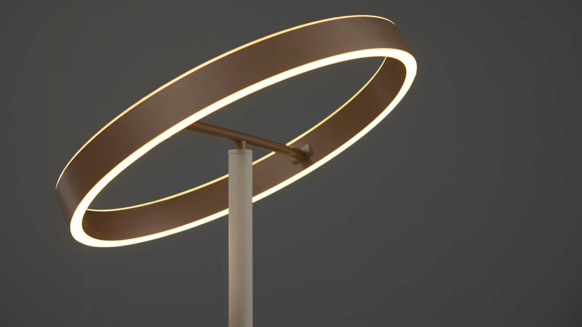 Moderner beigefarbener LED-Fluter in Ringform mit flexiblem Lesearm