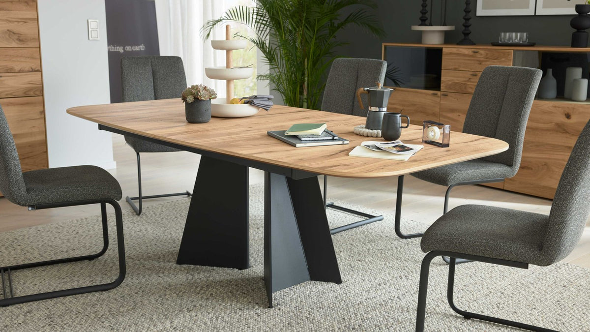 Moderner Esstisch mit abgerundeter Holzplatte und schwarzem Design-Untergestell